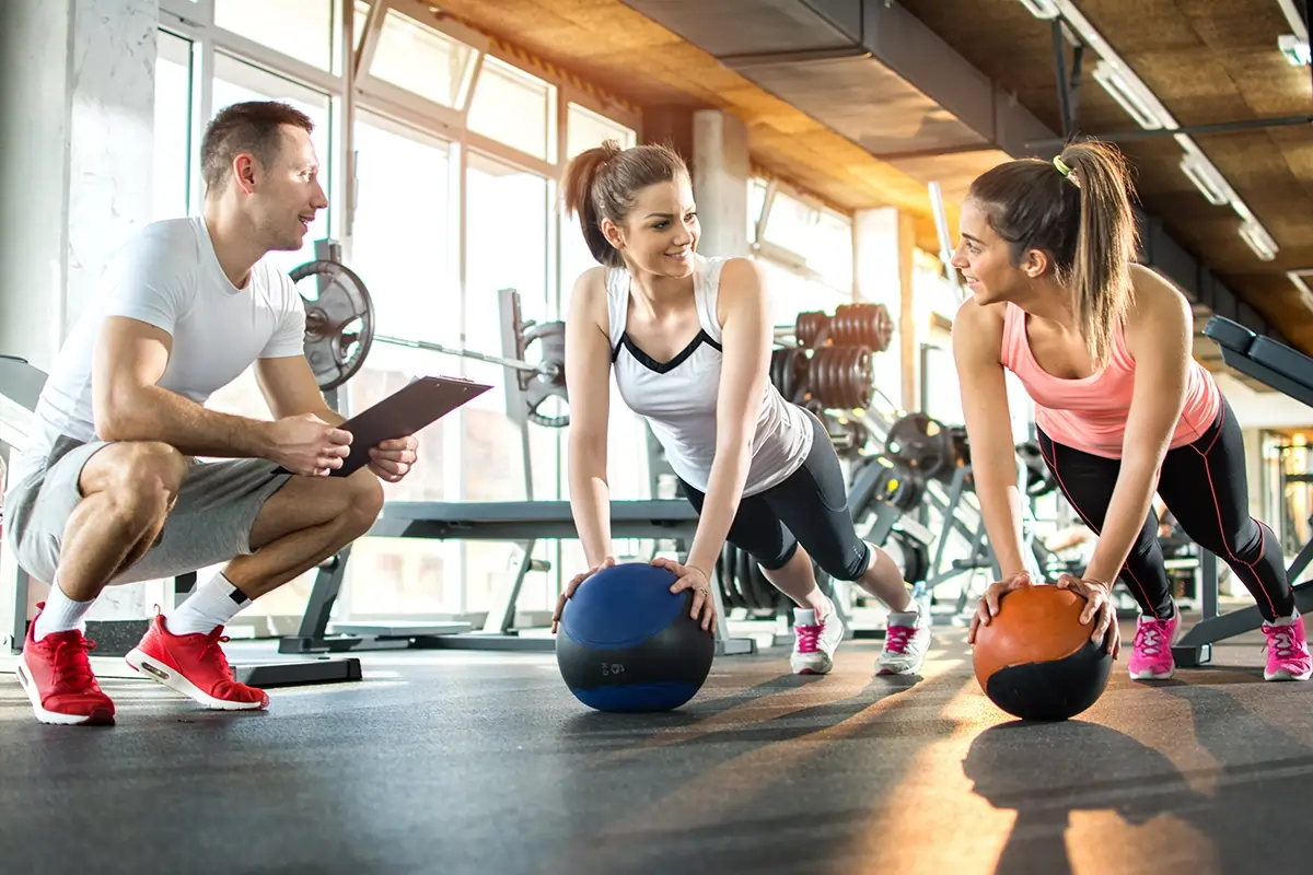 a fitness trainer with two women